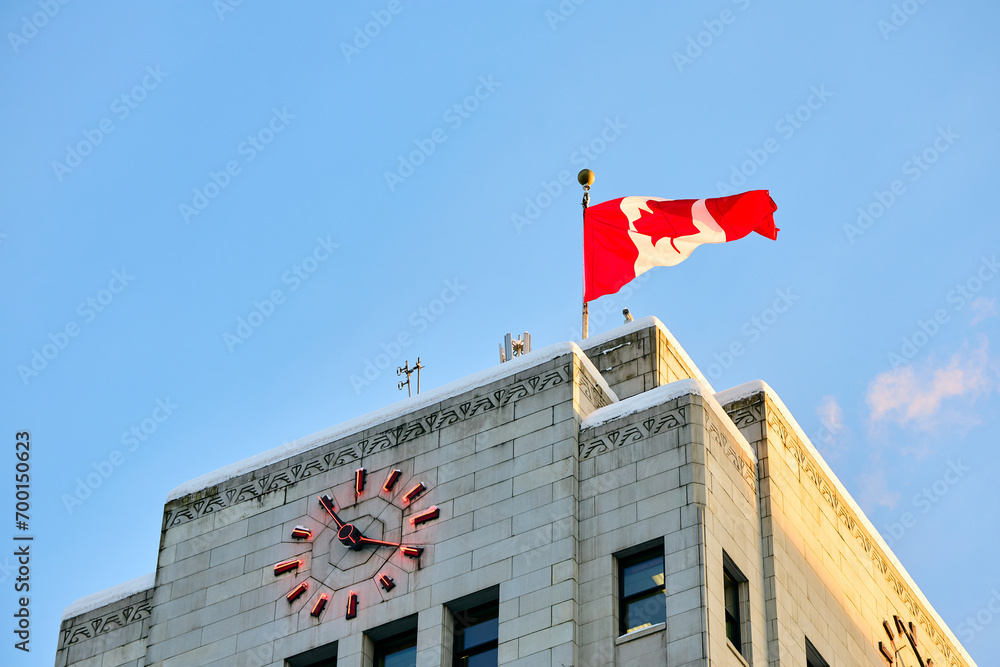 Fototapeta premium Below view Vancouver City Hall with Canadian flag.