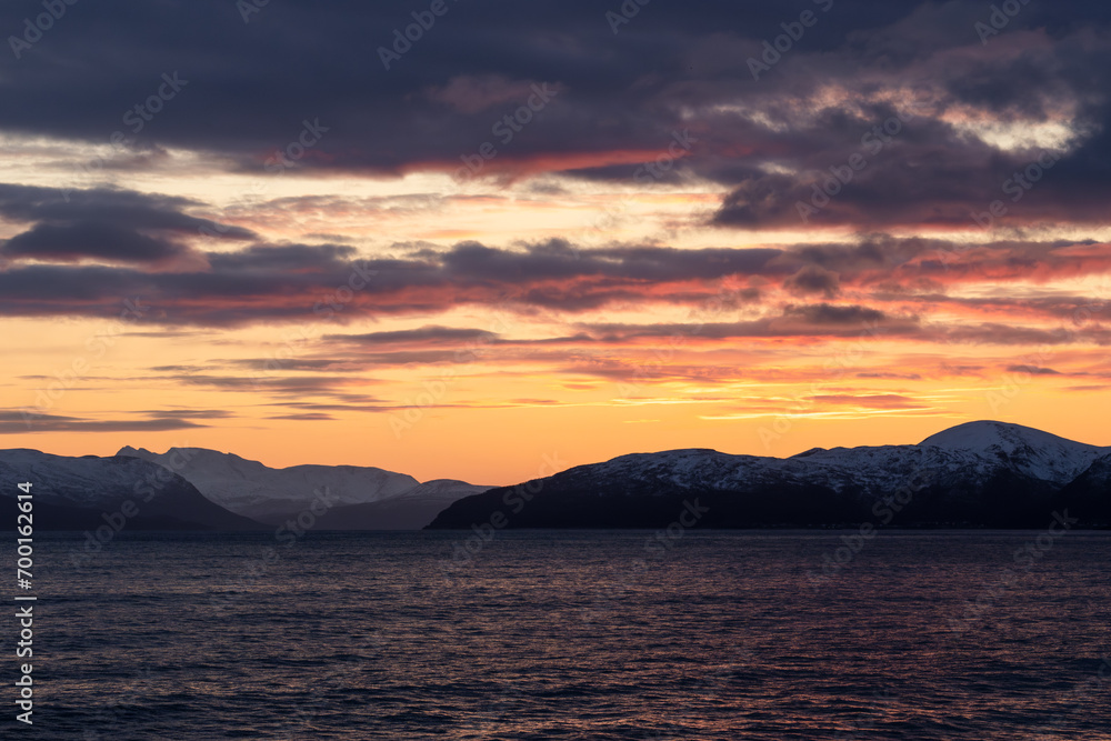 Sunset over the fjords of Norway, beautiful cloud cover and color over the ocean