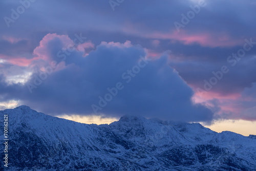 A purple sunset over the snowy mountains of Norway in the Arctic
