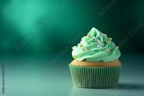 Delicious decorated cupcake with leaf clover Shamrock Toppings on Lush Green Background, space for text. St. Patrick's Day celebration