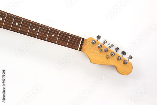 Selective focus, electric guitar neck on white background with copy space. Love, entertainment and music concept.