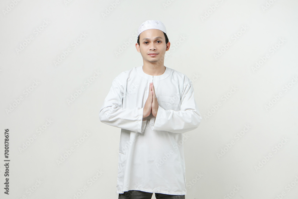 happy asian muslim man greeting gesture. People religious Islam lifestyle concept. celebration Ramadan and ied Mubarak. on isolated background. happy asian muslim man greeting gesture. People religious Islam lifestyle concept. celebration Ramadan and ied Mubarak. on isolated background.