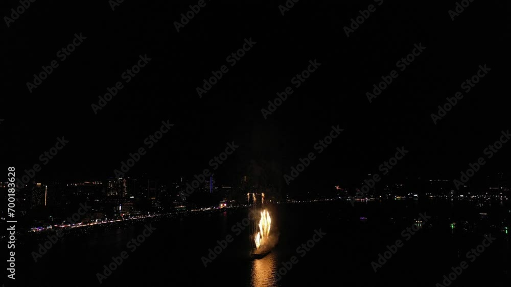 Aerial top view of Celebration day. Skyline with fireworks light up sky over landmark skyscraper on the sea in Pattaya International Fireworks Festival, Thailand. Holidays, celebrating New year. Aerial top view of Celebration day. Skyline with fireworks light up sky over landmark skyscraper on the sea in Pattaya International Fireworks Festival, Thailand. Holidays, celebrating New year.