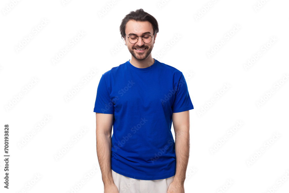 young smart caucasian man with dark well-groomed hair and a beard in a blue t-shirt on a white background young smart caucasian man with dark well-groomed hair and a beard in a blue t-shirt on a white background