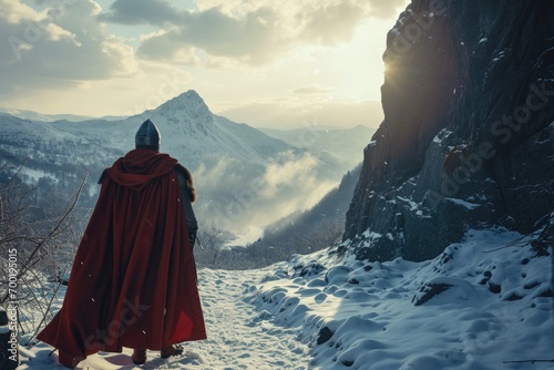 Fotografia Medieval knight in a snowy landscape, red cape billowing, looking towards a distant mountain