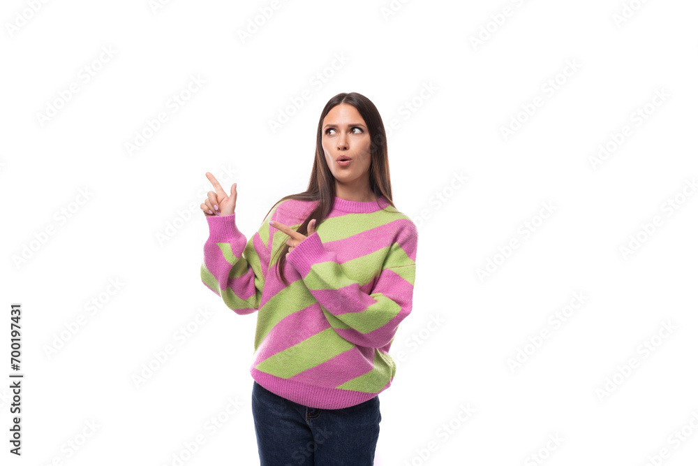 young caucasian promoter woman with black hair dressed in a pink striped blouse actively gesticulates on a white background with space for advertising young caucasian promoter woman with black hair dressed in a pink striped blouse actively gesticulates on a white background with space for advertising