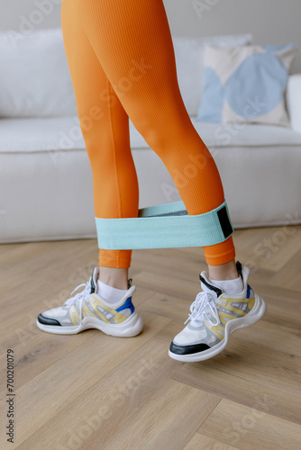 Woman in sportswear doing exercises at home