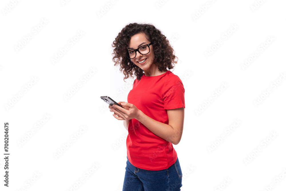 young promoter woman dressed in a red basic t-shirt chatting in a smartphone young promoter woman dressed in a red basic t-shirt chatting in a smartphone