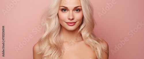 portrait of a  blonde beautiful woman on a pink background abstract © Basel