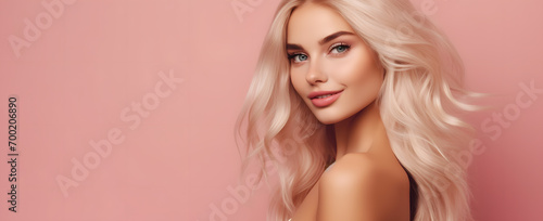 portrait of a blonde beautiful woman on a pink background abstract
