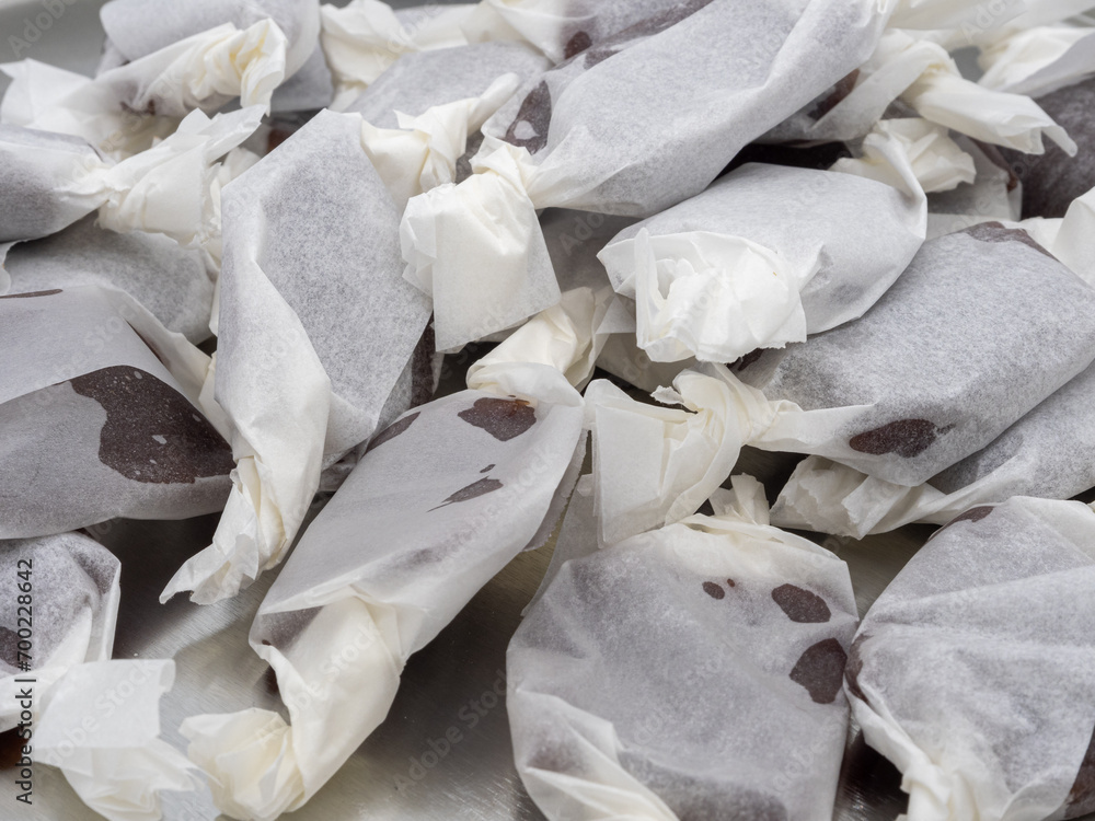 Closeup view of handmade fudge candies wrapped in paper. Closeup view of handmade fudge candies wrapped in paper.