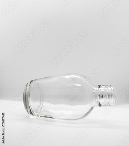 Empty bottle glass lying on white background with copy space for text.