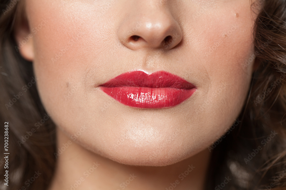 Obraz premium Beautiful female lips with red lipstick closeup beauty portrait