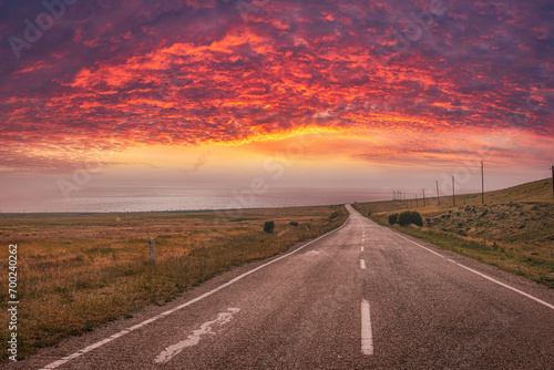 Road into sunset with dramatic sky and clouds. Armenia 