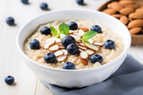 Nutrient-rich Breakfast Bowl: Organic Oatmeal Porridge with Blueberries, Yogurt, and Almonds.