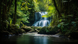 A cascading waterfall hidden in a lush and remote jungle surrounded by vibrant foliage and the soothing sound of flowing water.
