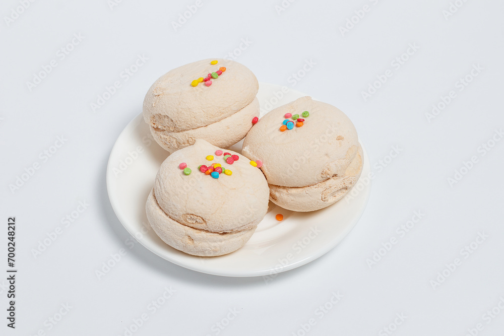 Marshmallows of different colors on a white background Marshmallows of different colors on a white background
