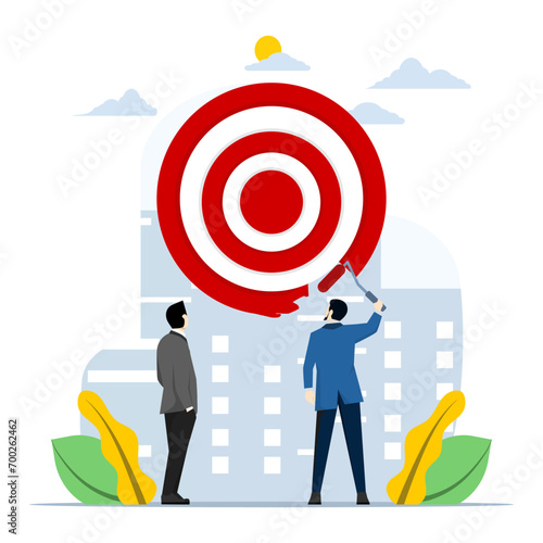 KPI concept, key performance indicators or setting and achieving goals, Goals, setting goals or business targets, ambitious businessman using paint roller to paint dartboard, archery target.