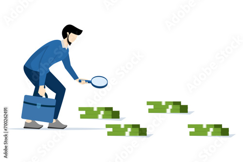 concept of looking for investment opportunities, curious businessman with magnifying glass checking and tracking dollar bills, financial success, checking how to generate profit and income.