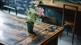 Vase of flowers on the wooden table in coffee shop, stock photo