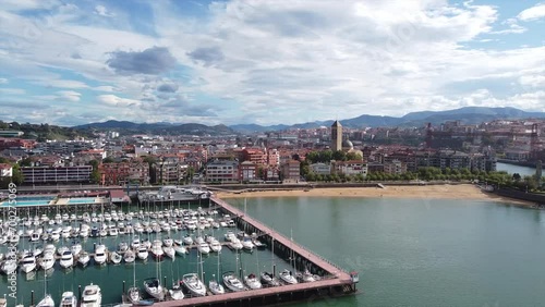 Drone video of a flight over the coast of a city in Spain during a sunny day