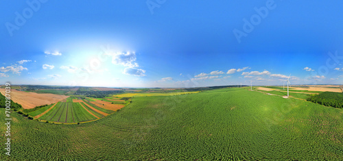 360 panorama of the agricultural field with summer landscape and wind turbines. Beautiful summer landscape photo