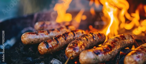 grilling bratwursts on fire photo