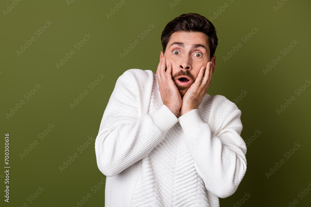 Photo of terrified scared man wear trendy clothes hand touch cheeks omg bed news isolated on khaki color background Photo of terrified scared man wear trendy clothes hand touch cheeks omg bed news isolated on khaki color background