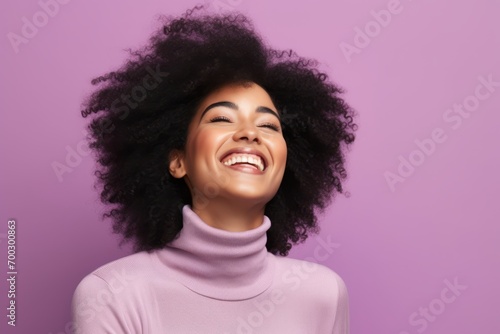 Portrait of beautiful african american woman with afro hairstyle laughing © Juan Hernandez
