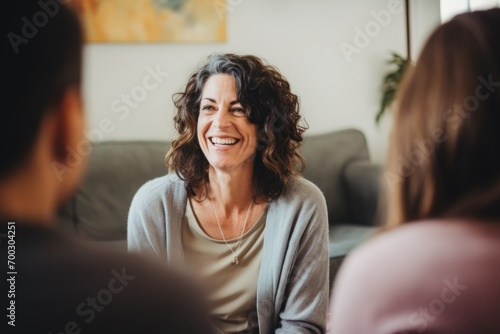Middle aged female therapist doing group therapy at home photo