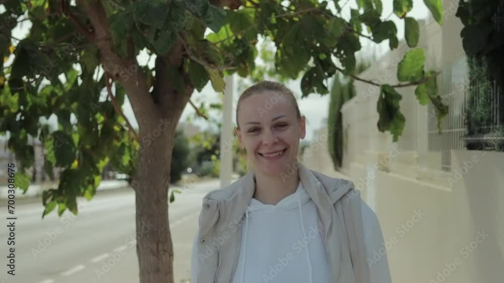 Slow motion of an attractive blonde woman.a happy smiling young woman walking down the street. Slow motion of an attractive blonde woman.a happy smiling young woman walking down the street.