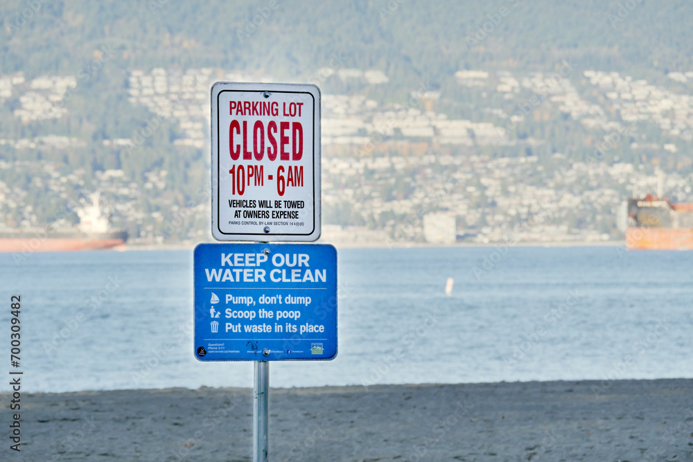 Parking Lot closing time and Clean Water signs at Jericho Beach in Vancouver, British Columbia, Canada