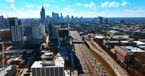 Multiple cars travel by the wide multi-lane roads of Atlanta, Georgia, USA. Sunny cityscape of busy metropolis from top view. photo