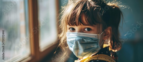 Returning to school after Covid-19 quarantine and lockdown, a child wears a face mask.