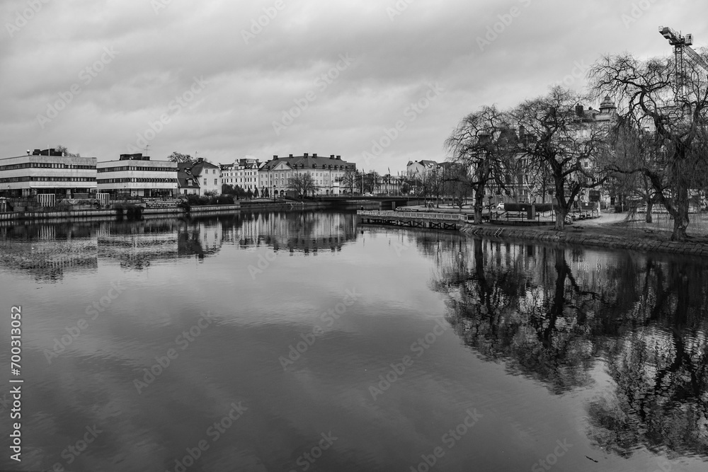 A river through the city in black and white