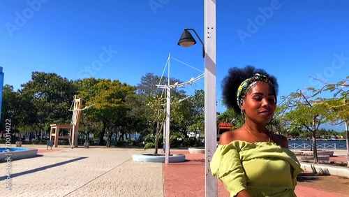 Dramatic slow motion shot of Afro Cuban woman dancing in a park