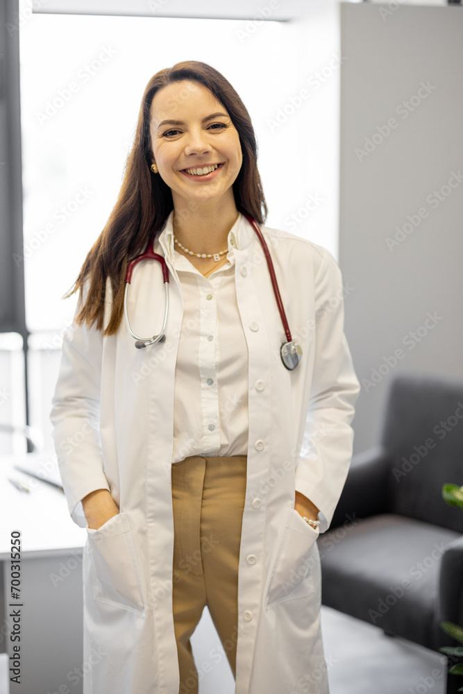 Portrait of a cheerful female doctor in medical office. Medical director of a private clinic Portrait of a cheerful female doctor in medical office. Medical director of a private clinic