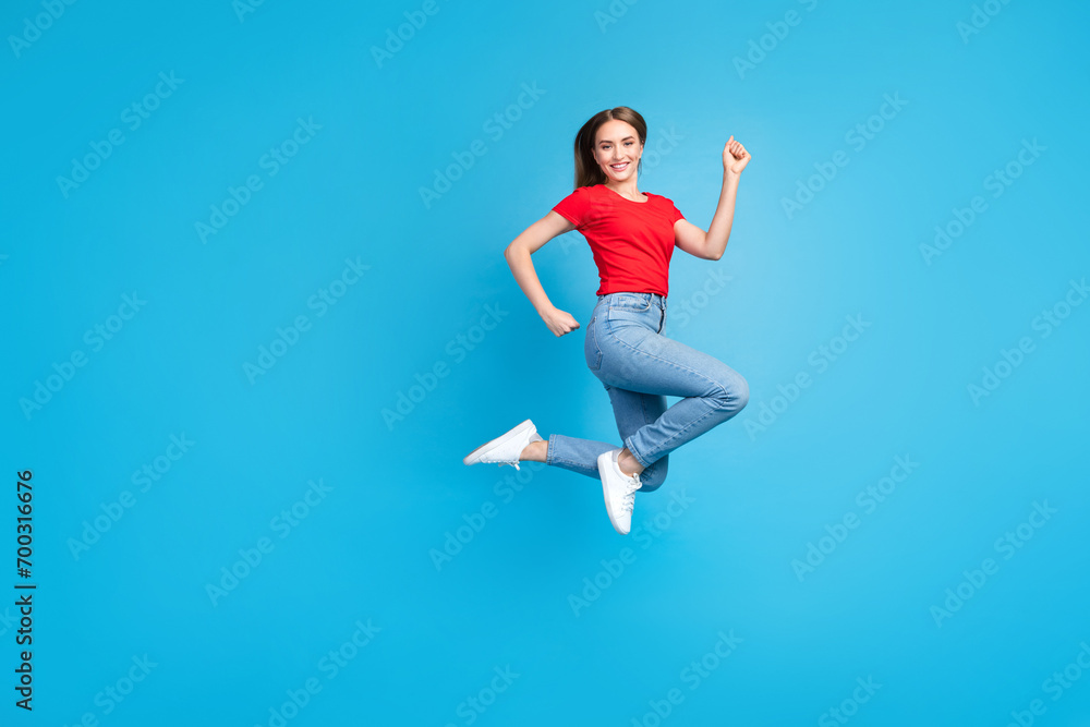 Photo of sporty optimistic girl dressed trendy outfit advertising clothes collection isolated on blue color background Photo of sporty optimistic girl dressed trendy outfit advertising clothes collection isolated on blue color background
