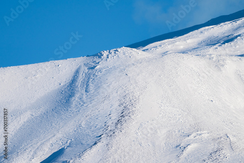 Obraz na płótnie Bronte town under the snowy and majestic volcano Etna and a cloudy blue sky w salonie