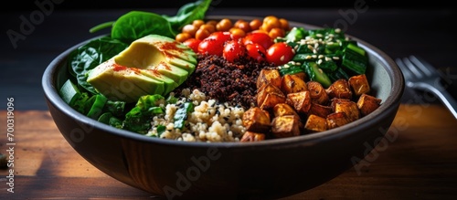 Focused Buddha bowl with roasted chickpeas, spinach, quinoa, and selective ingredients.