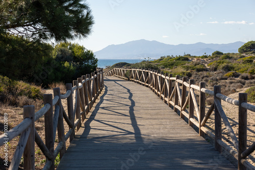 wooden path towards the mediterranean sea with a clear sky