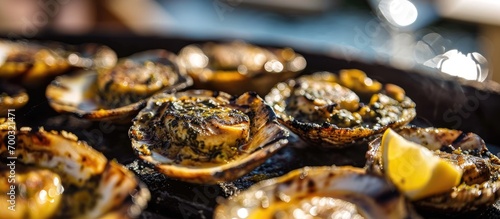 Grilled limpets with lemon, a traditional dish in Madeira and a typical snack in the Canary Islands. photo
