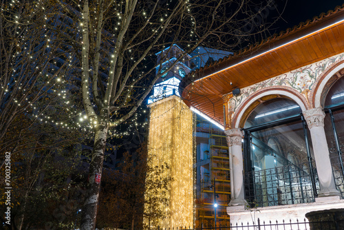 Albania, Tirana city. clock tower an mosque decoration with light night light photo