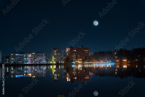 Albania, Tirana lake night all building light reflect in lake, and moon