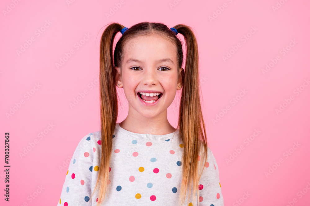 Portrait of funky optimistic schoolgirl with ponytails hairdo dressed dotted sleepwear smiling laugh isolated on pink color background Portrait of funky optimistic schoolgirl with ponytails hairdo dressed dotted sleepwear smiling laugh isolated on pink color background