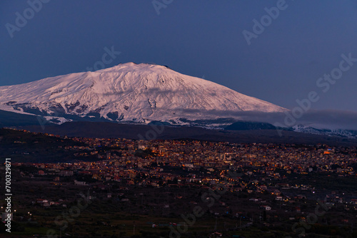 Obraz na płótnie Bronte town under the snowy and majestic volcano Etna and a cloudy blue sky w salonie