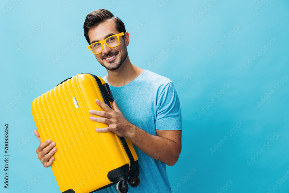Yellow man travel traveler suitcase trip baggage studio background happy journey flight weekend vacation - obrazy, fototapety, plakaty 