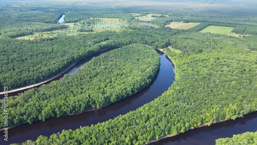Flying over a very winding river and forest in Northern Minnesota near the border of Canada photo