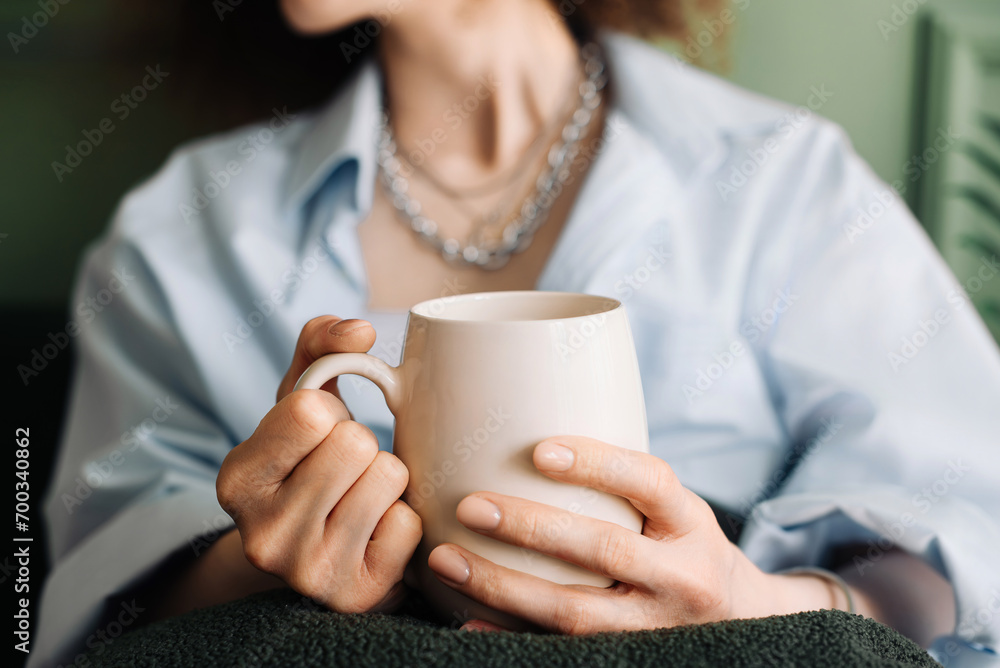 Millennial Woman Relaxing with Tea on Living Room Couch, Cropped Interior View. Leisure Time. Young Woman Enjoying Relaxation and Tea in Living Room Interior Millennial Woman Relaxing with Tea on Living Room Couch, Cropped Interior View. Leisure Time. Young Woman Enjoying Relaxation and Tea in Living Room Interior