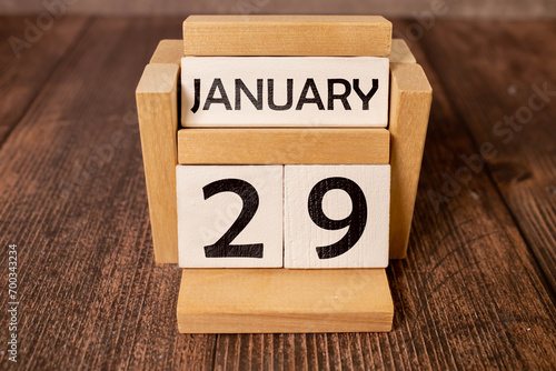 January 29. Day 29 of month. Calendar cube on wooden background photo